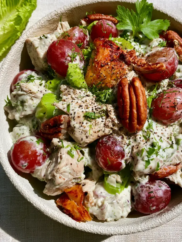 Slightly angled shot showing the texture of hand-shredded chicken and toasted pecans. (Chicken Salad Recipes)