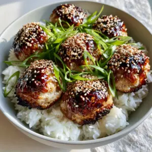 Close up of seared Asian chicken meatballs with visible charred edges and thick amber glaze.