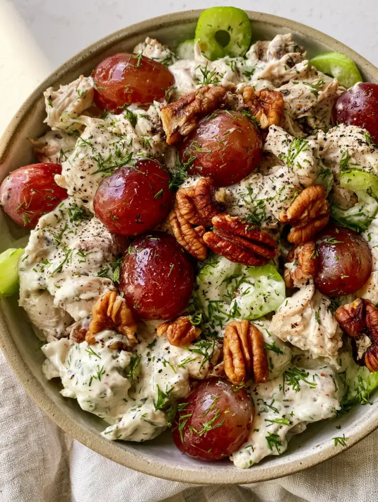 Chicken Salad with Grapes: The Ultimate Creamy and Crunchy Hand-Pulled Recipe 2 Macro view of chunky hand-pulled chicken salad with grapes, ivory-white dressing, and cracked black pepper.